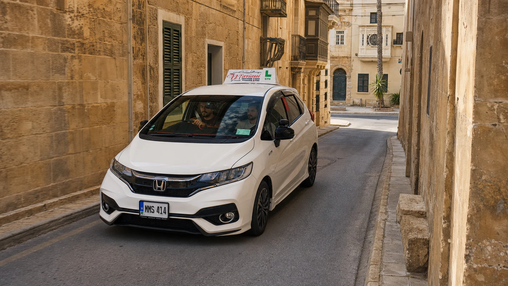 A narrow two-way street in a Maltese village core
